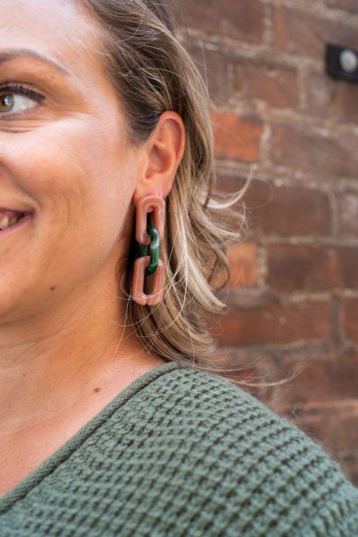 Woman wearing Tabitha Chunky Chain-Link Earrings, bold forest green and vintage rose links visible.