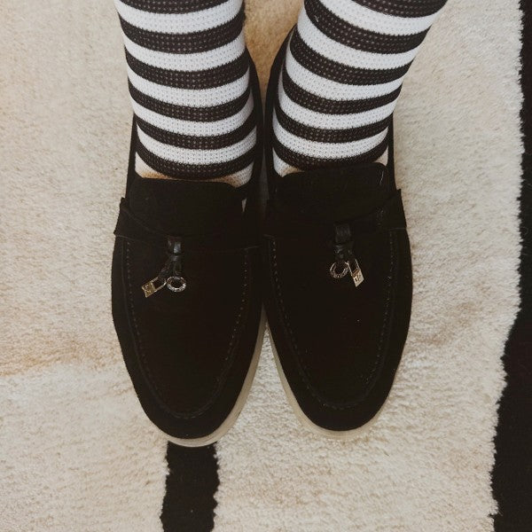 Woman wearing black and white striped Urban Stripes Socks paired with casual shoes.