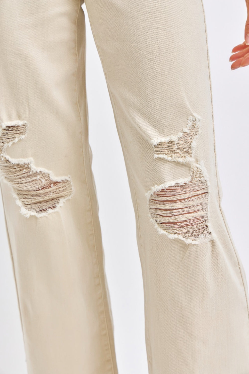 Close-up of knee distressing on Malinda High Waist Wide Leg Jeans in bone, highlighting trendy worn-in details.
