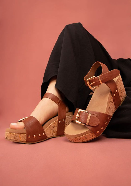 Side angle of cognac Romy Platform Sandals showing wedge platform and center seam vegan leather upper.