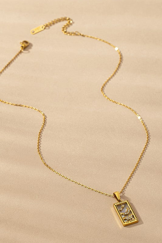 Tarot Card Moon Pendant Necklace with black onyx background and crescent moon design on gold-tone chain.