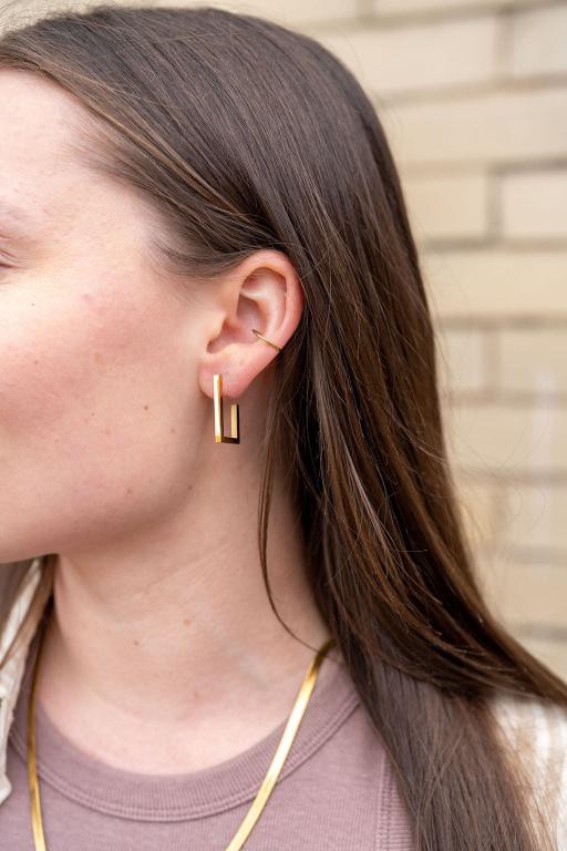 Woman wearing Goldi Luxe Silver Square Hoop Earrings, bold square shape visible.