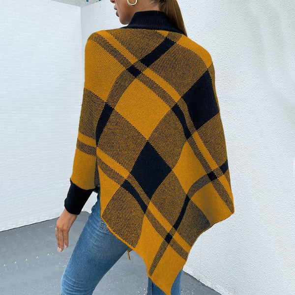 Back of woman wearing Murphie Plaid Knit Poncho, fall plaid knit design with mock neck and cozy texture