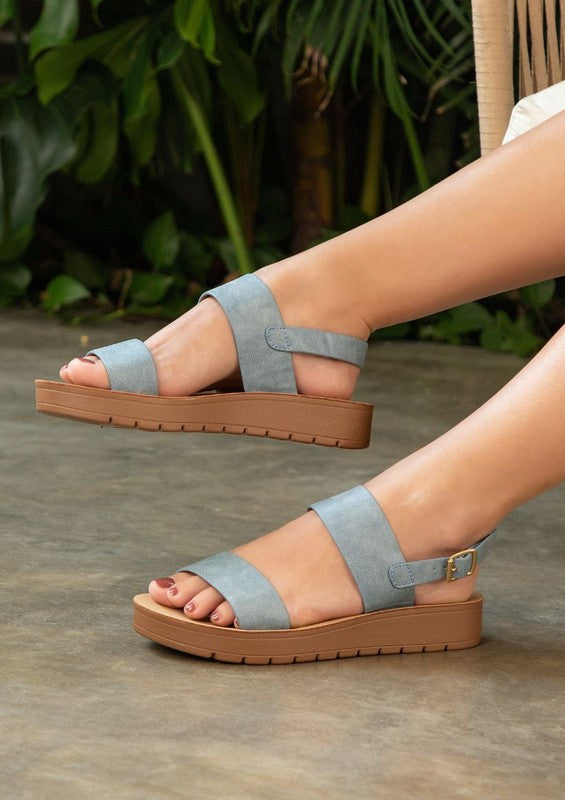 Vanya blue slingback flatform sandals with vibrant vegan leather straps.