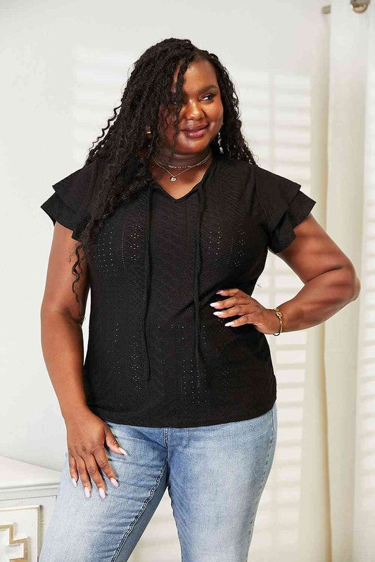Black plus size Tami Eyelet Tie-Neck Top with delicate eyelet fabric and soft flutter sleeves.
