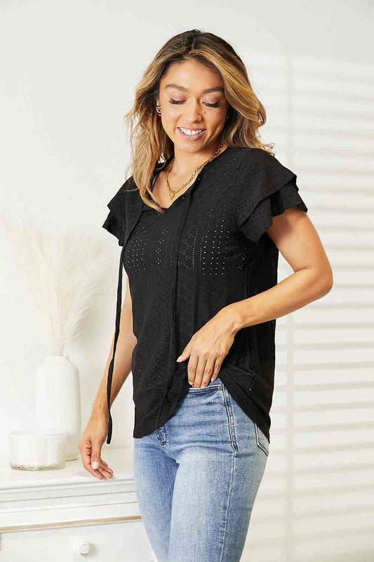 Black Tami Eyelet Tie-Neck Top with flutter sleeves and feminine eyelet design for a casual yet polished look.