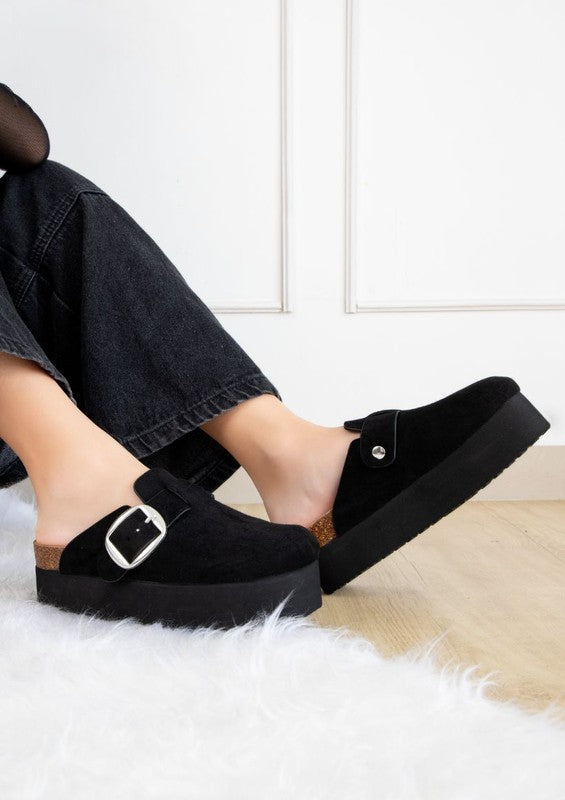 Angled view of black suede Jasmine Slip-On Platform Clogs with silver buckle.