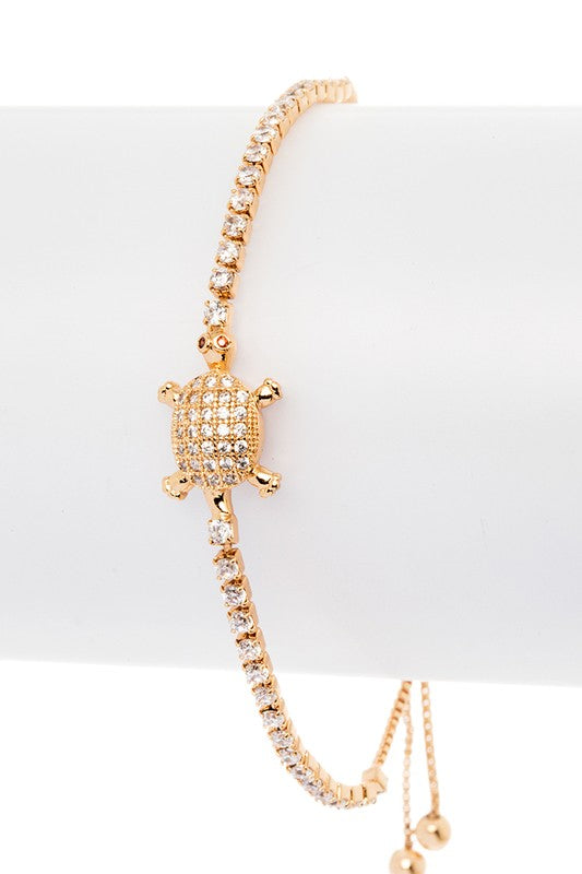 Gold turtle pavé string bracelet with cubic zirconia accents, displayed to show the sparkling turtle charm.