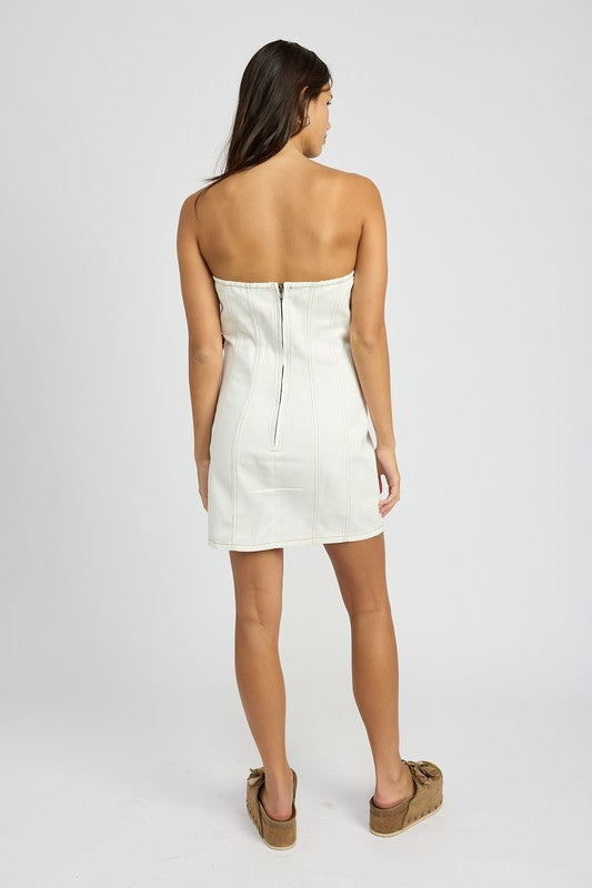 Back view of model in white Ryanne Denim Tube Dress with zip closure and corset fit.