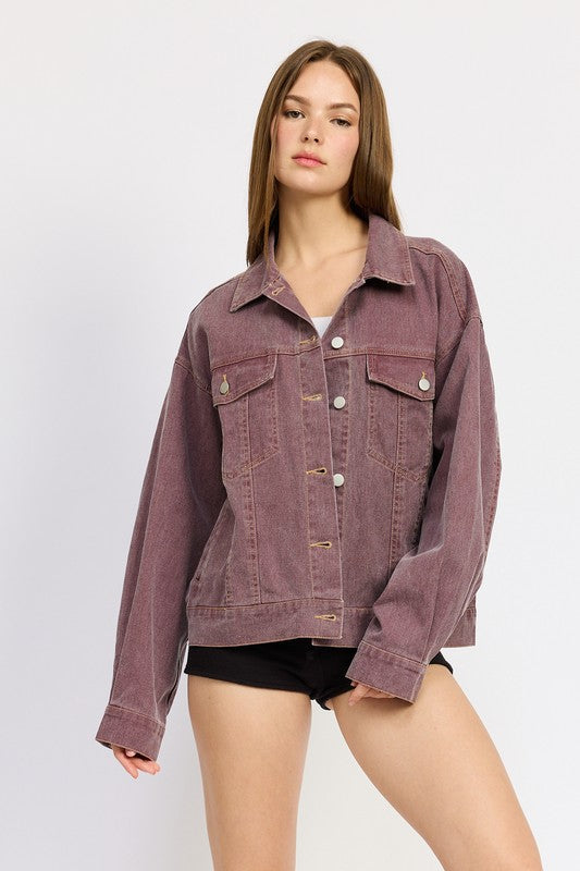 A stylish woman showcases the Mila Oversized Denim Jacket in berry, featuring a relaxed fit, silver button closures, and patch pockets for a cool, casual look.