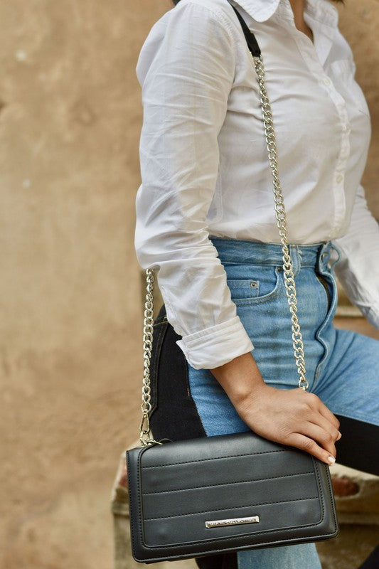 Woman wearing olive MKF Dora Crossbody Bag over shoulder with removable strap.