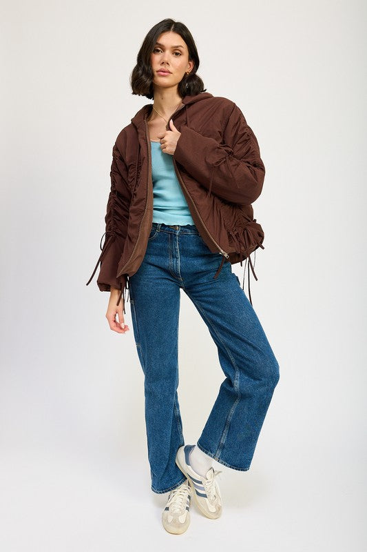 Model full body wearing brown Candes Ruched Puff Jacket with jeans