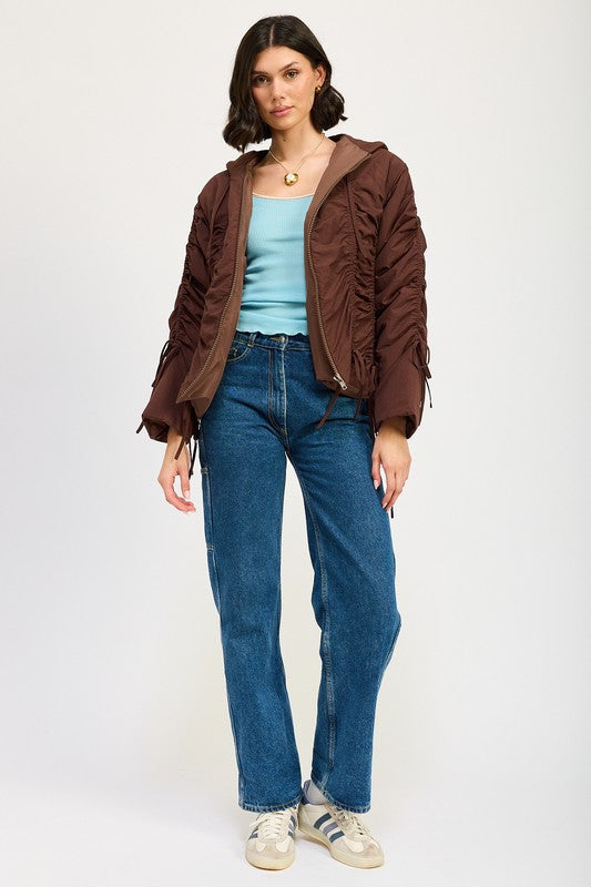 Full body model in brown Candes Ruched Puff Jacket styled with denim