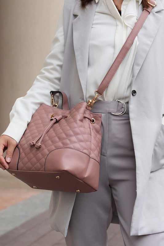 Model carrying Mauve MKF Collection Wendy Bag with matching wristlet displayed.