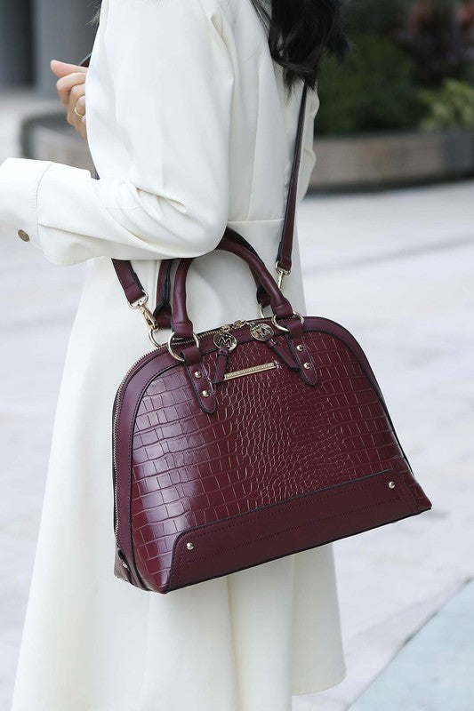 B9001ED44A428920D627CC7874CFF21D/2234Model carrying Eggplant Nora Satchel on shoulder wearing white outfit.2988_fe7aa5f4-db8f-43c6-ae6b-ff1e02656428.jpg