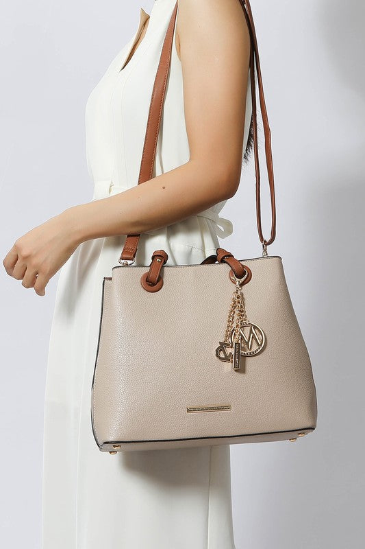 Woman wearing taupe Kearny tote over shoulder, vegan leather handbag.