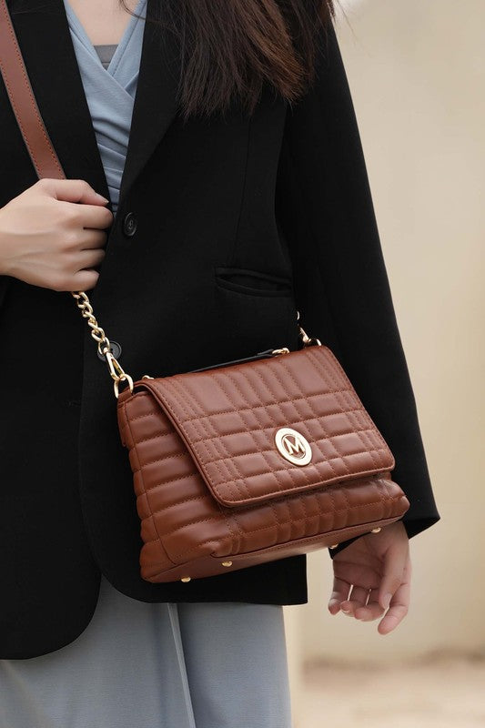 Model wearing MKF Lola Quilted Brown Bag styled crossbody for casual day look.