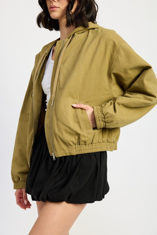 Bryn Denim Hoodie in khaki, side close-up showing zipper, pocket, and elastic cuff