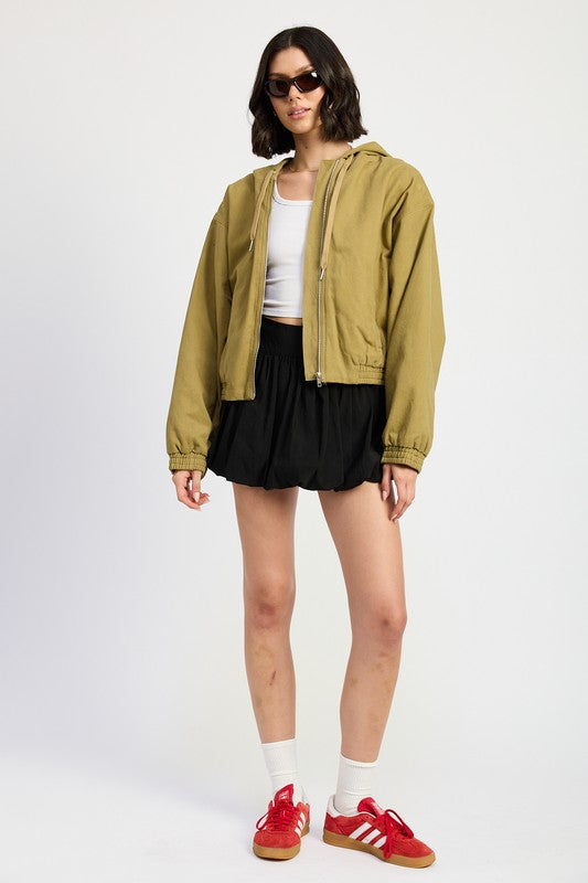 Bryn Denim Hoodie in khaki, full body styled with black skirt and sneakers