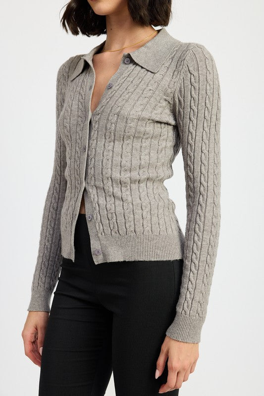 Close-up of Luiza gray cable knit cardigan showing button details and ribbed hem.