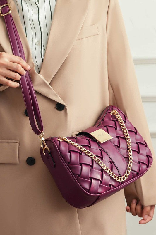 Woman wearing burgundy Solari Braided Chain Shoulder Bag crossbody style with woven exterior and braided chain strap.
