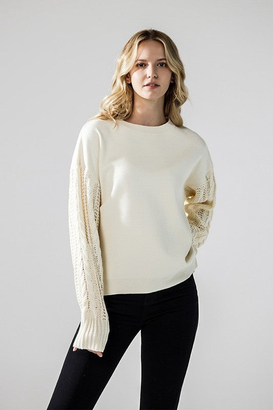 Relaxed fit ivory sweater with cable knit sleeves