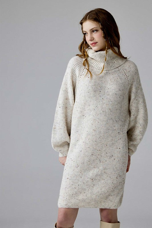 Front view Ottilie ivory turtleneck confetti sweater dress with balloon sleeves.