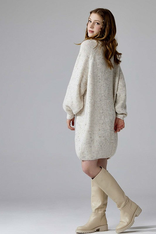 Side angle ivory oversized sweater dress with confetti knit and turtleneck
