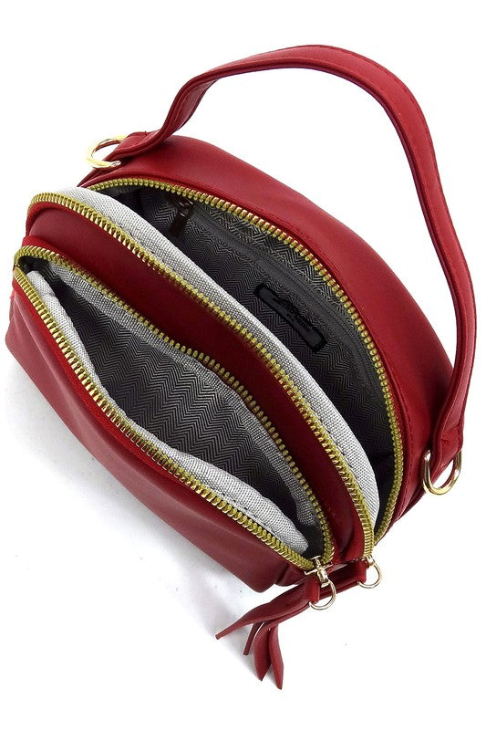 Top view of the red Cadie Top Handle Crossbody Bag with zip-top open, revealing multiple compartments for organized storage