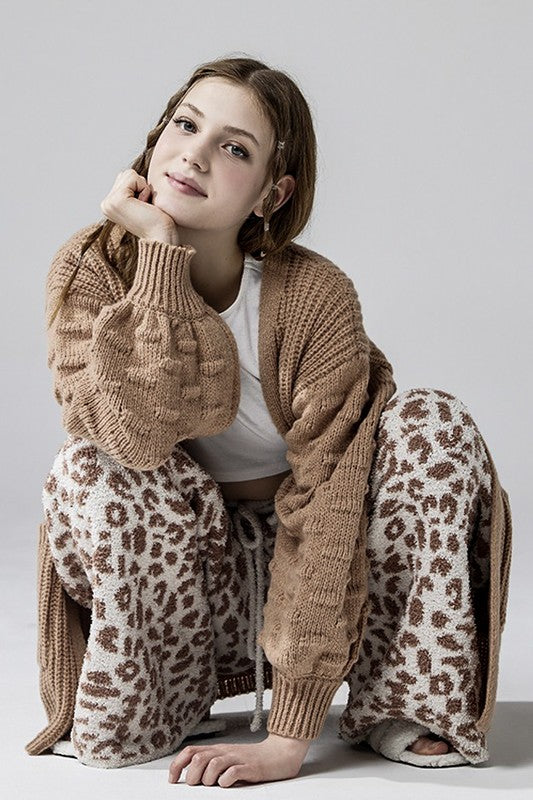 Aleah Plus Size Leopard Lounge Pants in cream with camel print, crouched pose showing fuzzy knit