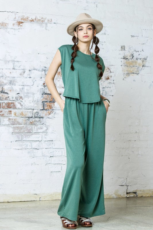 Front view of Kora Wide Leg Jumpsuit in washed army green with layered top effect.