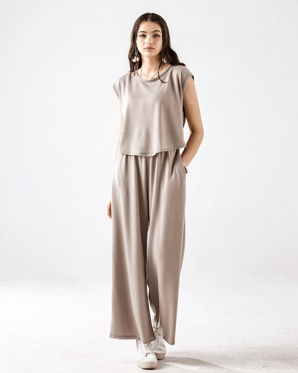 Kora Wide Leg Jumpsuit in light mocha with relaxed wide-leg fit and pockets.