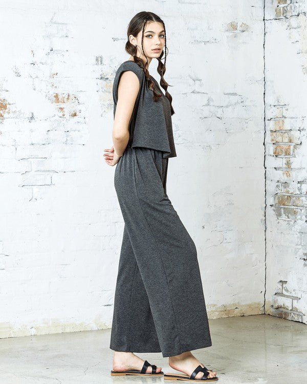 Side view of Kora Wide Leg Jumpsuit in charcoal with relaxed wide-leg design.