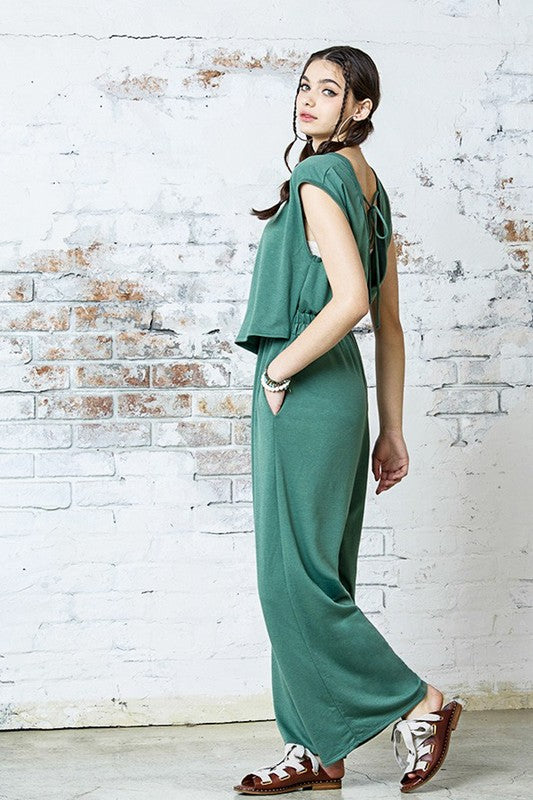Side view of Kora Wide Leg Jumpsuit in washed army with relaxed wide-leg fit.