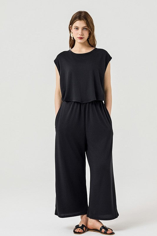 Full body front view of Kora Wide Leg Jumpsuit in black with layered look.
