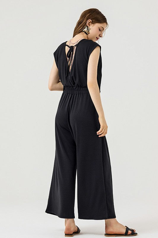 Back view of Kora Wide Leg Jumpsuit in black with open tie-back design.