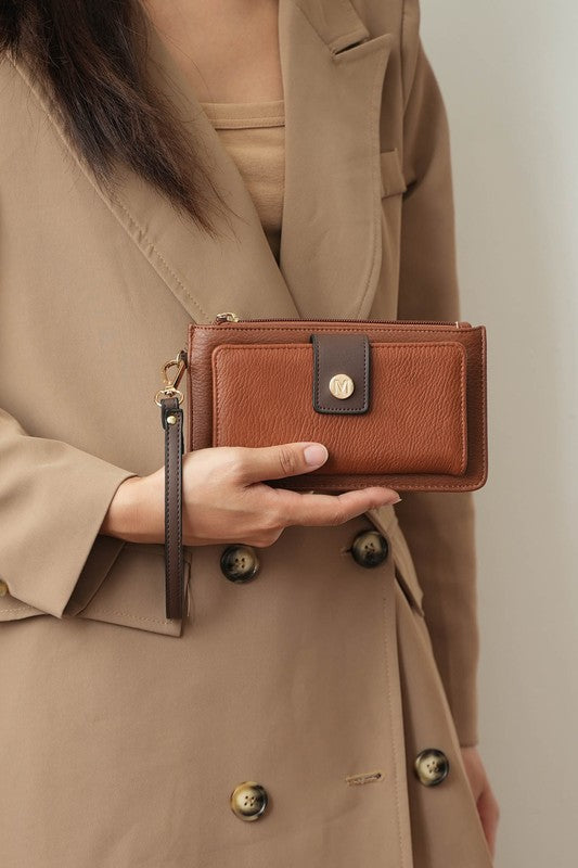 Woman holding brown MKF Liv Tote Bag wallet in hand.