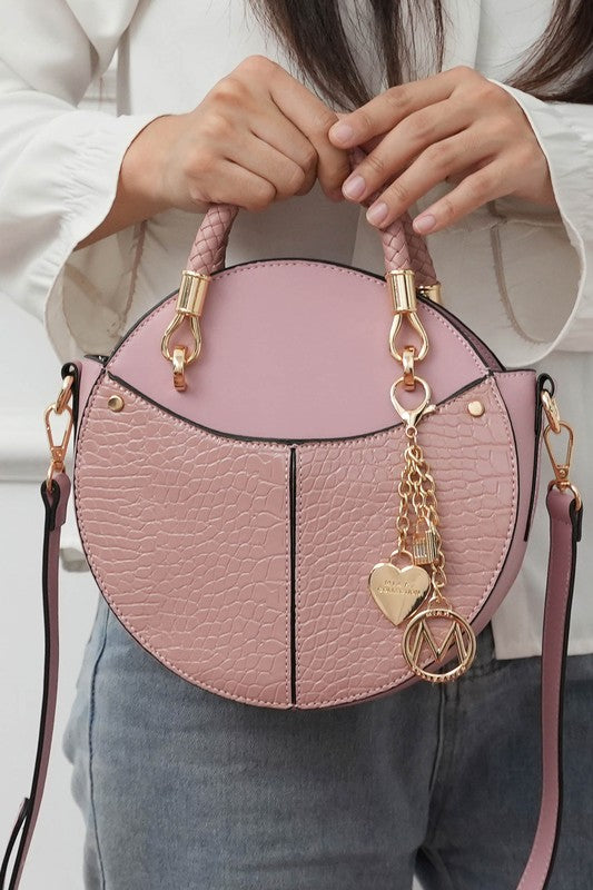 Woman holding blush Nobella Croco Crossbody MKF Collection by Mia K. by handle.