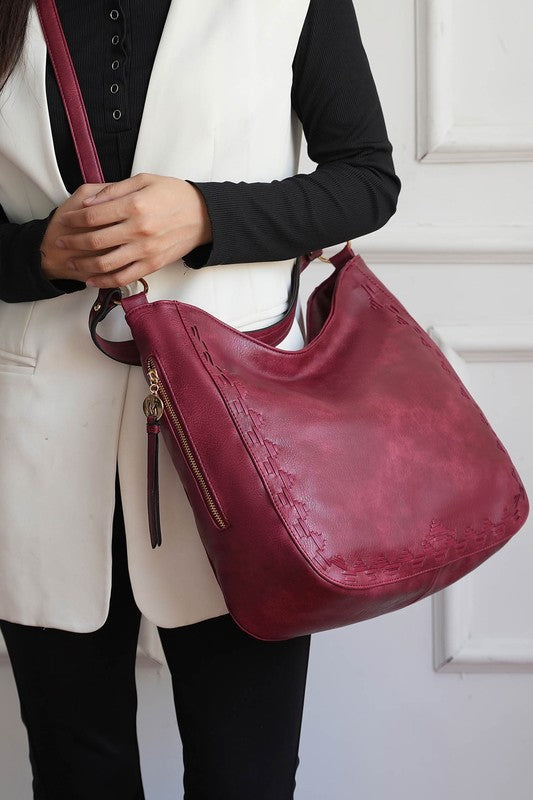 Woman wearing red MKF Lucille bag crossbody style, gold-tone hardware accents.