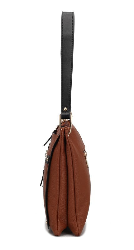 Side view of cognac/black Aliyah shoulder bag showing depth and stitching.