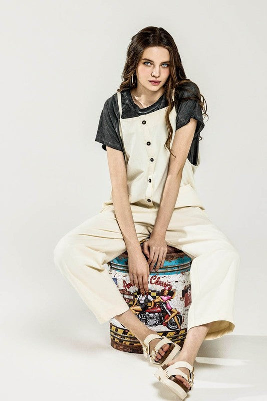 Dayana Plus Size Overall Jumpsuit in cream, model seated showing button-down detail