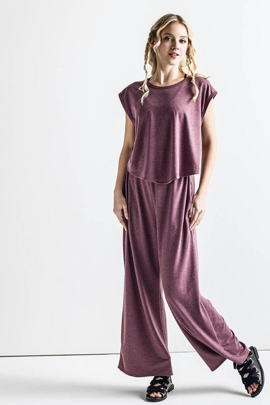 Relaxed fit Kora Wide Leg Jumpsuit in latte with wide-leg pants and pockets.