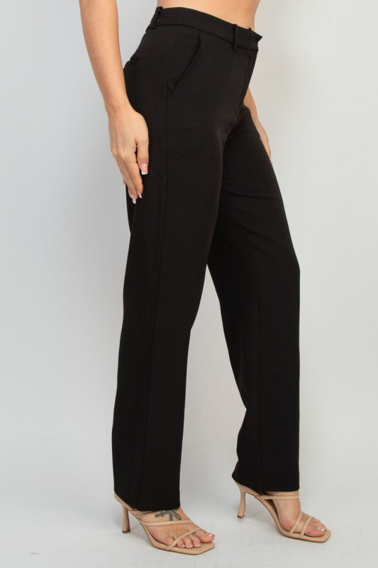 Side view of black dressy pants, midrise straight leg design with pockets, styled with button blazer.