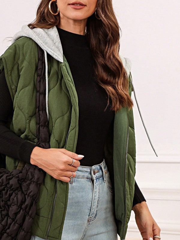 Model wearing the Meara Oversized Drawstring Hooded Zip Up Puffer Vest in olive, front angle view styled for a casual fall look.