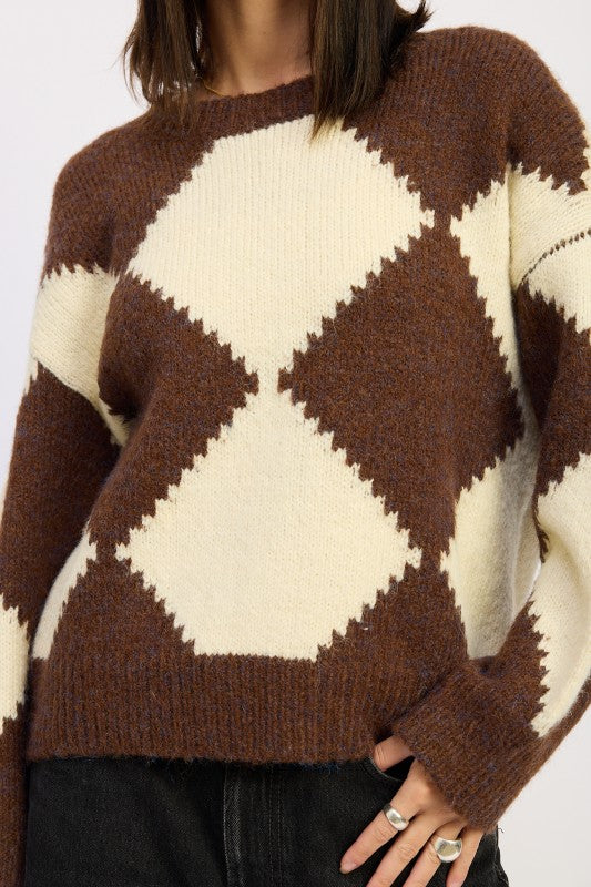Close up of Cassidy Sweater showing bold two-tone argyle knit pattern