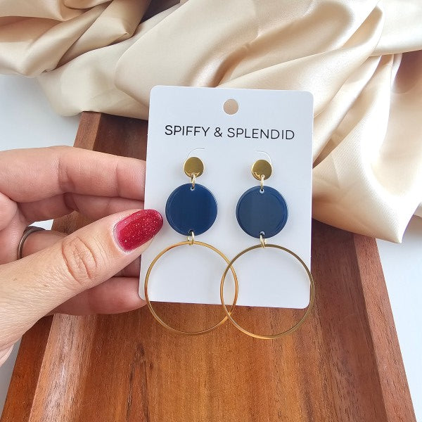 Navy acrylic Sadie earrings with gold-plated hoops and stud posts on a display card made by Spiffy & Splendid.