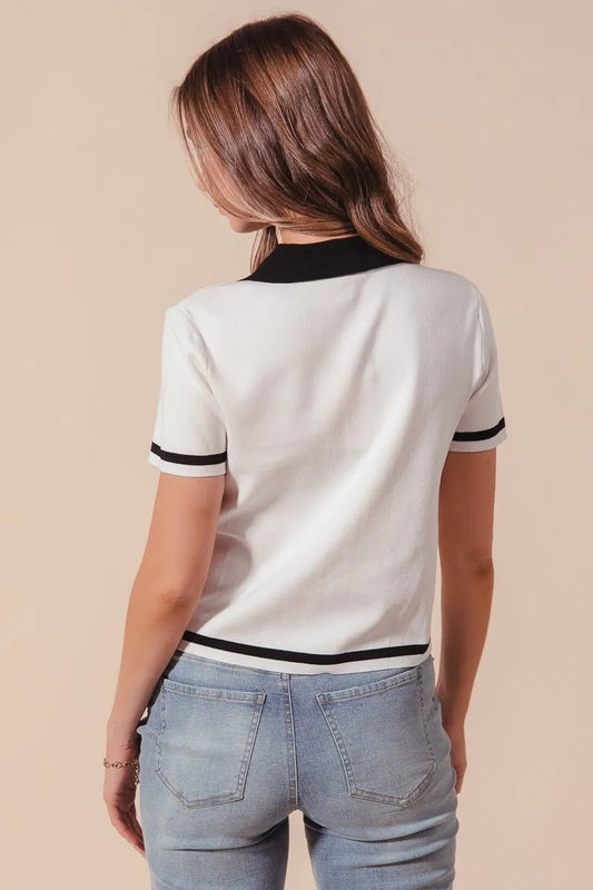 Back view of Novah ivory knit sweater shirt with black trim accents, showing clean silhouette