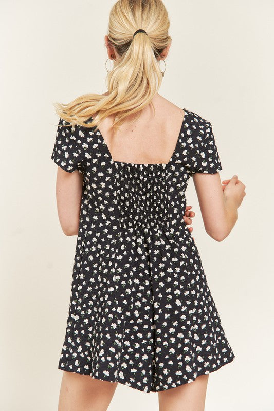 Back view of Xiomara Plus Size Floral Romper with smocked back and dark navy floral print.