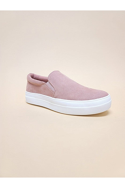 Angled side view of Tessa Slip-On Casual Sneaker showing 1.25-inch heel, dark mauve vegan leather upper, and white sole.
