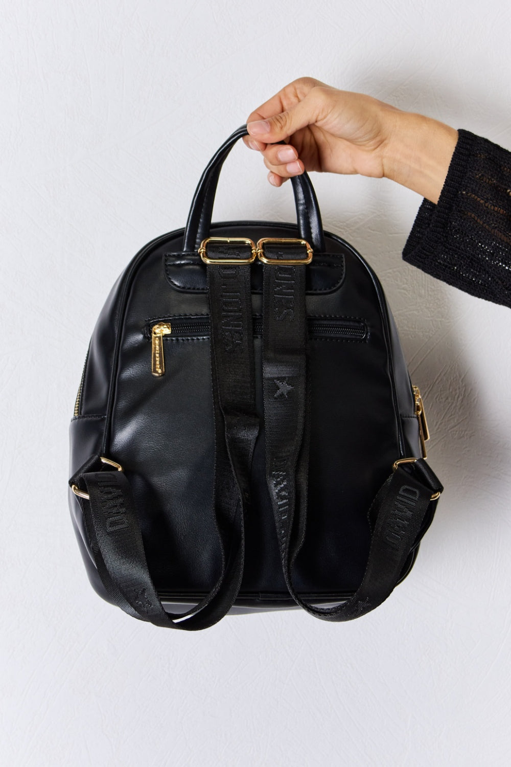 Back view of Garris black vegan leather backpack with adjustable straps.